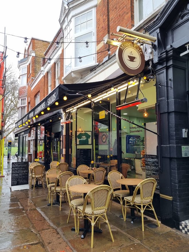 The frontage under its black awning on a wet morning