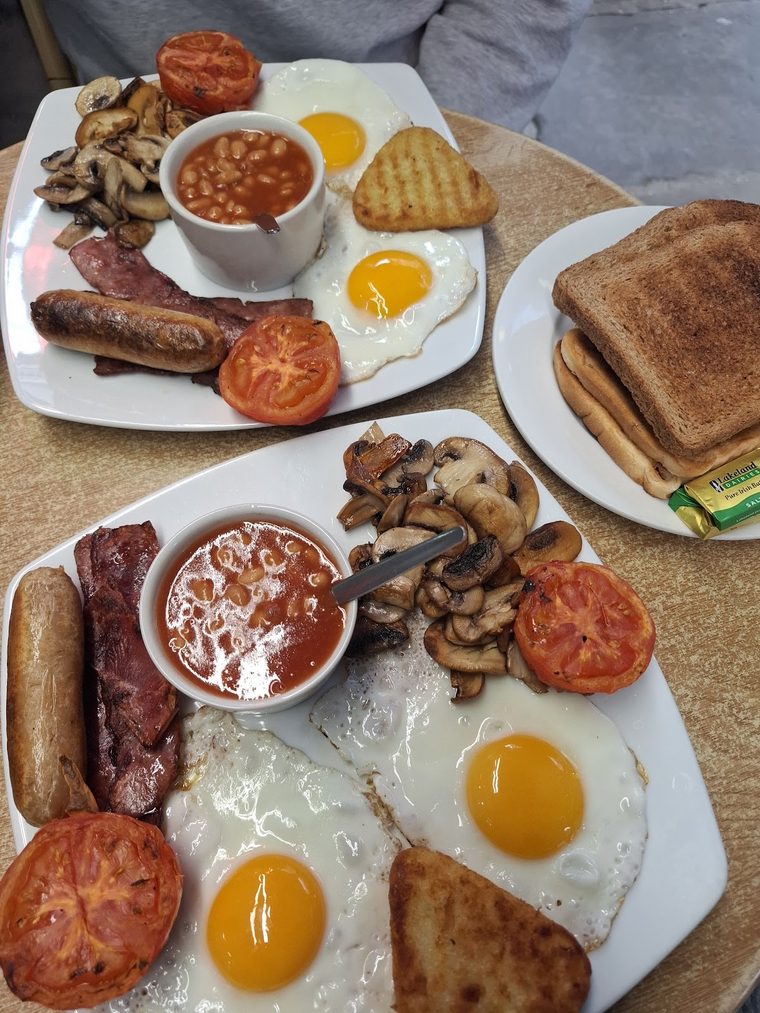 Two full English breakfast plates side by side